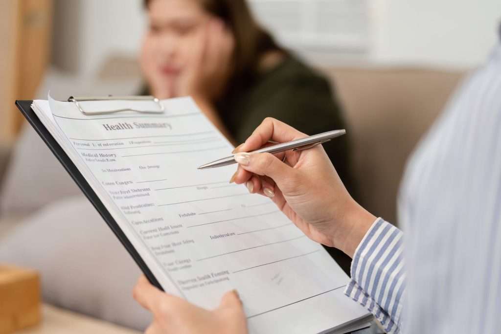 Health assessment 96064128 YI Healthcare provider consulting with patient about a personalized TruDose wellness program designed to support overall health, performance, and individualized care.