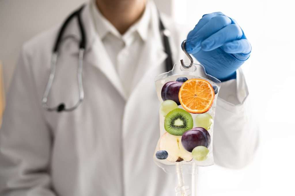 IV therapy 82890956 YI Doctor holding a vitamin IV infusion bag representing nutrient infusion therapy for hydration, immune support, energy, and overall wellness