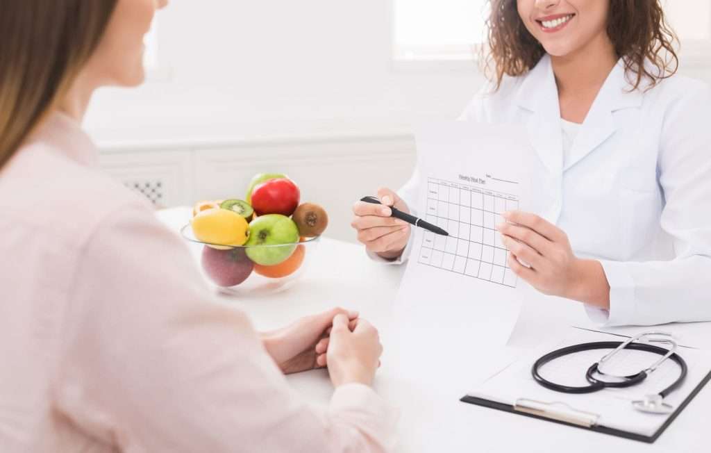 nutritional planning 102825122 YI Healthcare provider reviewing a personalized nutrition plan with a patient to address nutritional deficiencies and improve overall health.