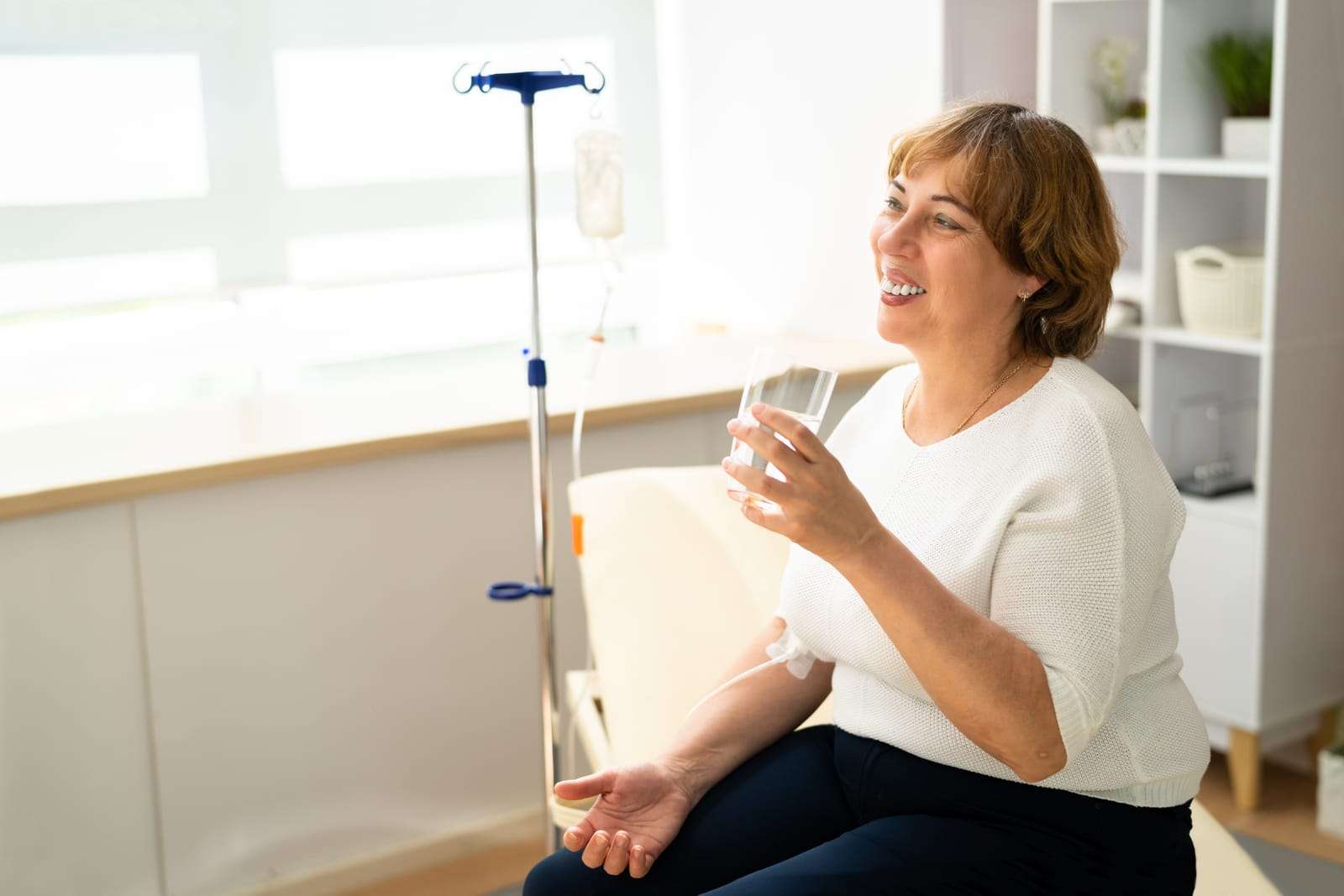 woman getting IV infusion 83188444 YI Patient receiving Multi-Pass Ozone IV therapy to support oxygenation, immune health, circulation, and overall wellness.