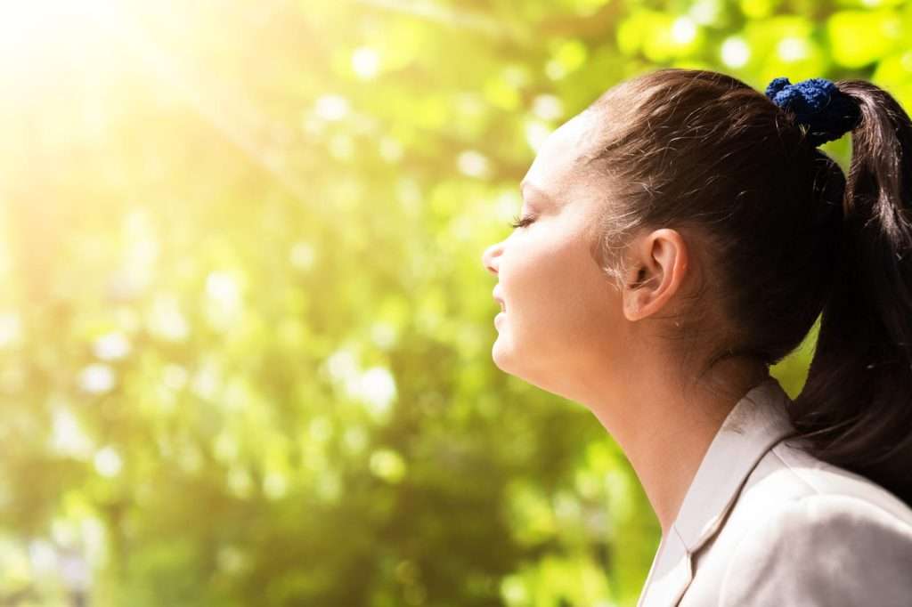 woman getting fresh air in sunshine 81793792 YI Patient receiving Ozone UVBI Therapy to support immune function, detoxification, oxygen utilization, and overall wellness